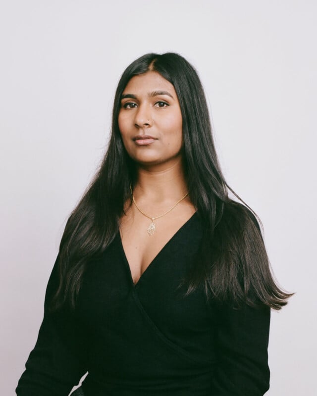 A woman with long hair wearing a black dress.