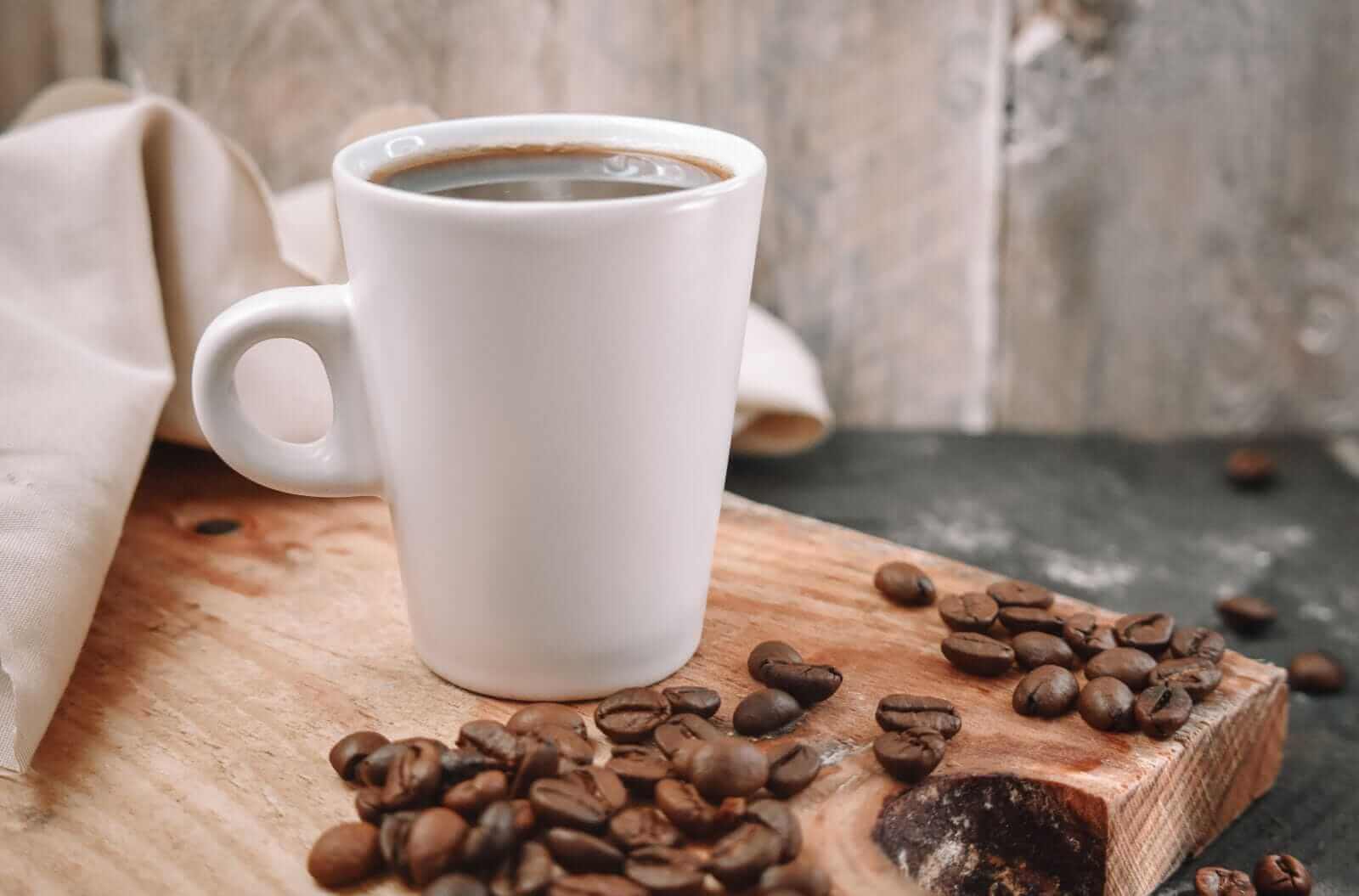 Cup of coffe with beans on the side by Carol La Rosa via Shutterstock