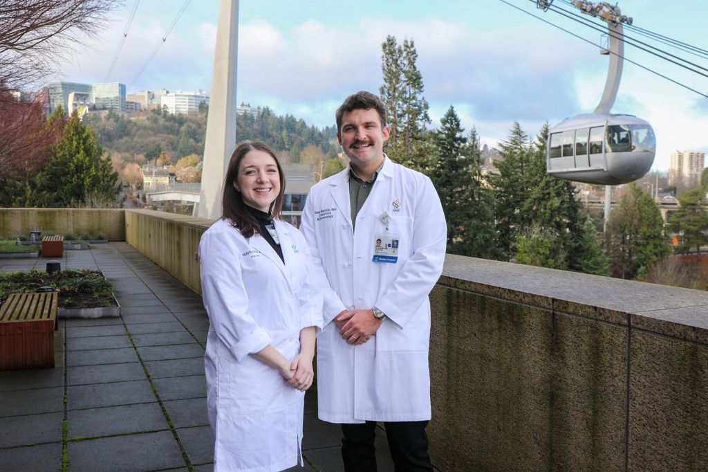 Left to right: Molly Kornfield and Sam Melville, M.D.s, smiling on the deck with the sky tram behind them. States with abortion restrictions have worse outcomes for patients using fertility treatment