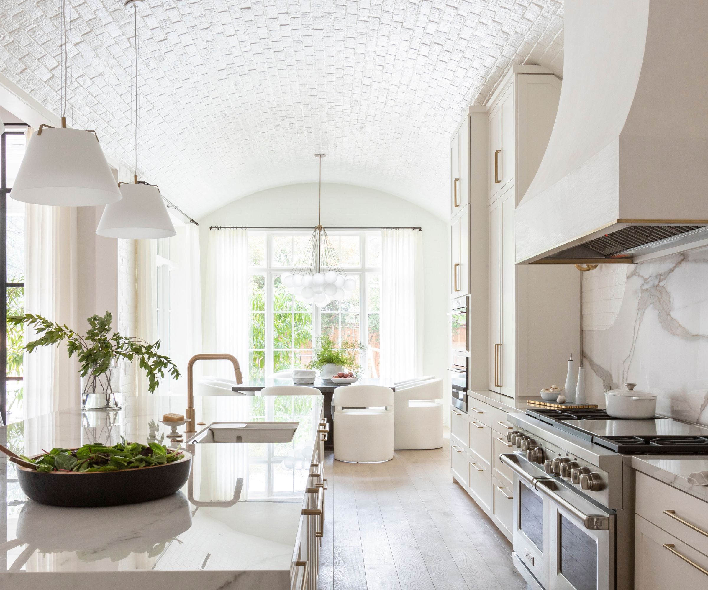 A neutral kitchen/diner with a curved ceiling