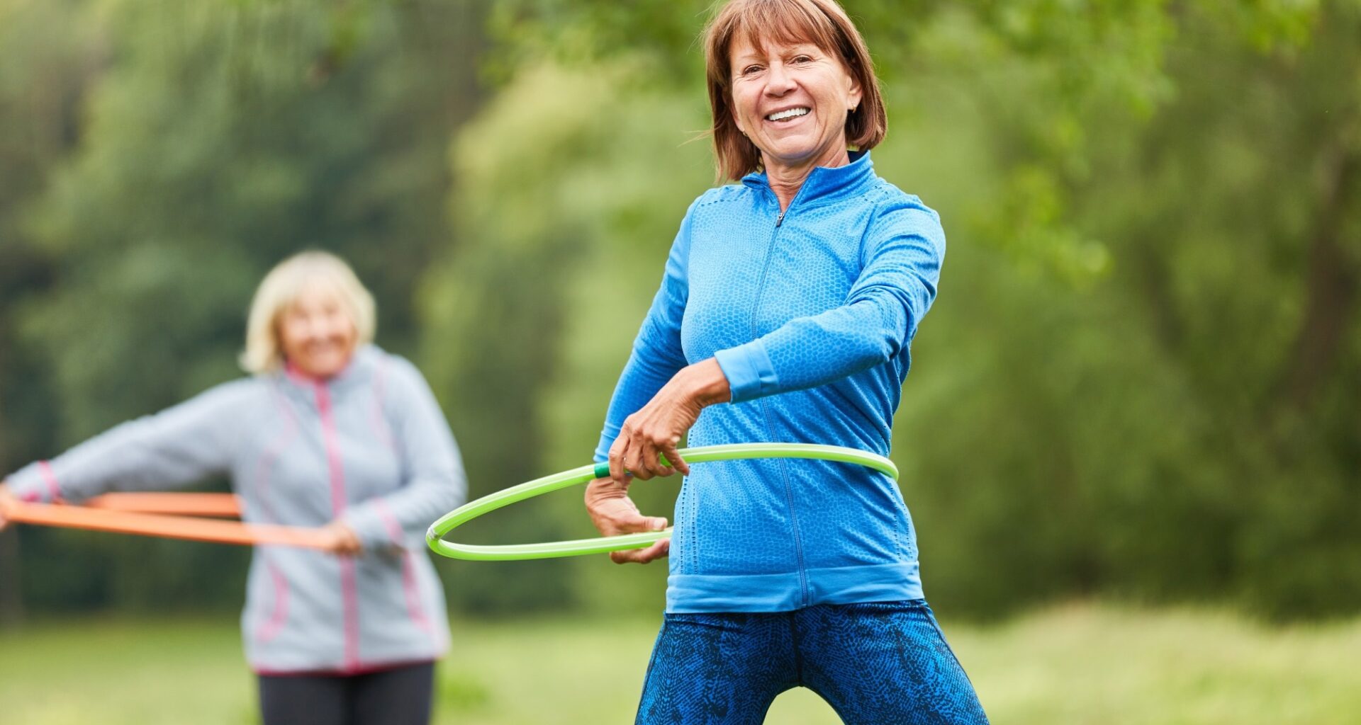 Senior women are doing exercise with hoop for fitness and coordination
