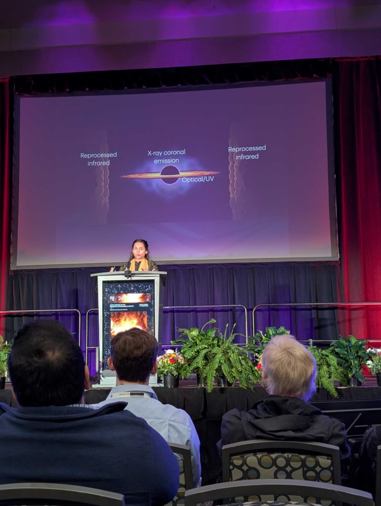 Dr. Tonima Tasnim Ananna delivering her Plenary Lecture at the AAS 247 meeting in Phoenix, Arizona. A cartoon of the different regions around an AGN disk can be seen on the screen behind.