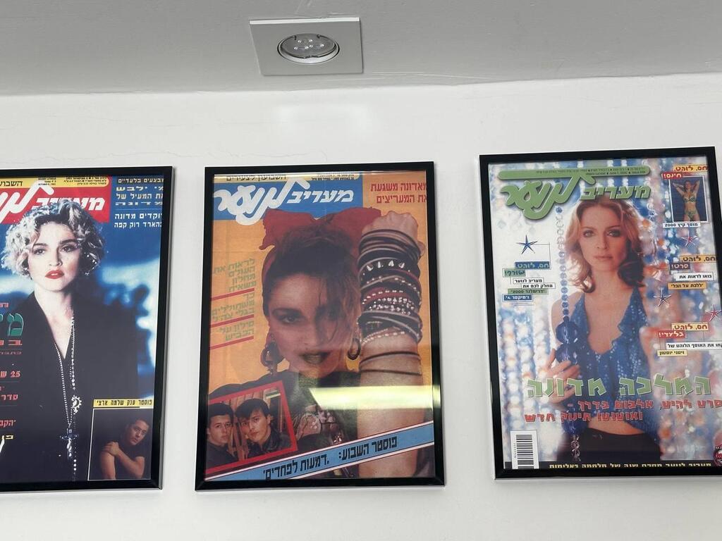 Framed covers of popular teen magazine Ma’ariv LaNoar featuring Madonna at various stages of her career, hang on the wall of collector Avihay’s home in Israel 