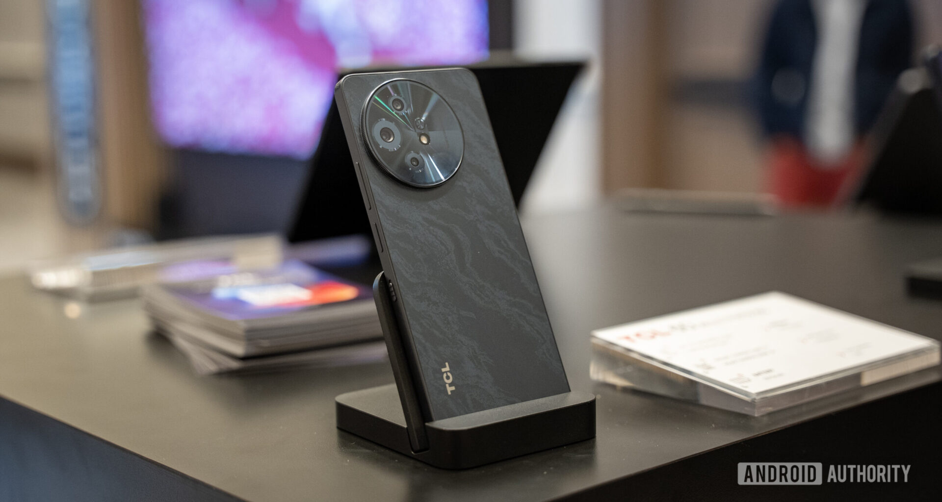 TCL 60 XE NXTPAPER 5G standing in a stand vertically