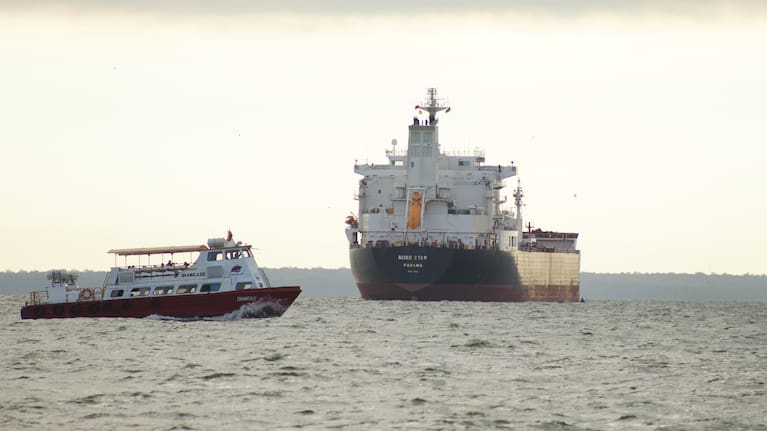A boat sails past the oil tanker Nord Star, Panama, on Lake Maracaibo, Venezuela.