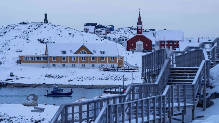 A boat travels at the sea inlet in Nuuk, Greenland.
