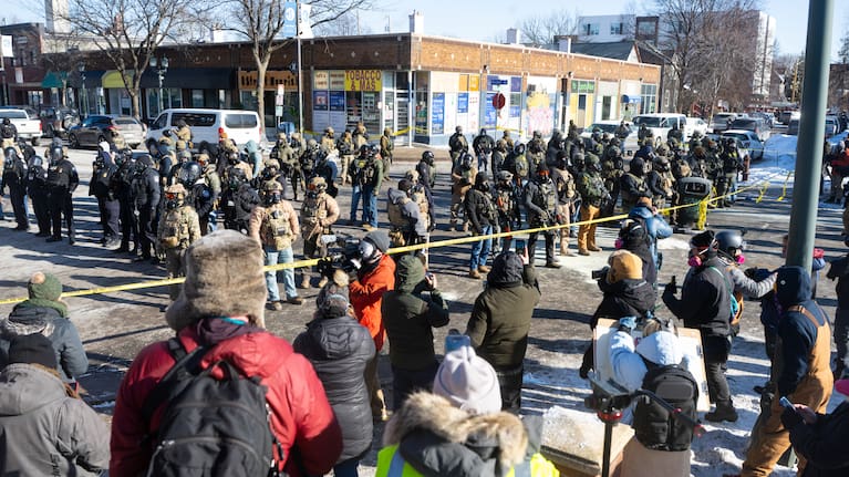 A large crowd gathers at the scene where federal agents fatally shot Alex Pretti in Minneapolis