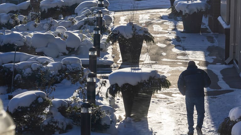 A person walks through the cold on the Campau Promenade in Grand Rapids.