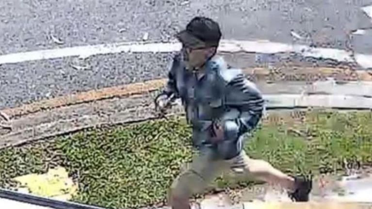 A still from CCTV of a man suspected of pouring hot liquid on a baby at a park in Brisbane. (Source: Queensland Police Service)