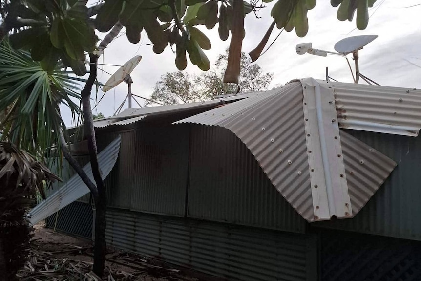 A building made of corrugated iron. It is damaged.