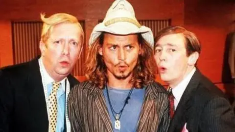 BBC Mark Williams, Johnny Depp and Paul Whitehouse in the suits you sketch from the Christmas 2000 special - Williams and Whitehouse are in their black suits, Depp wears a Stetson hat, a striped shirt and a blue T-shirt. They are all making an "Oooh" face.