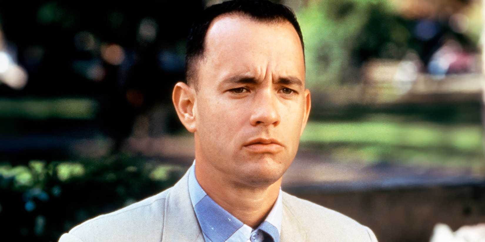 Tom Hanks staring ahead while sitting on the bench in Forrest Gump