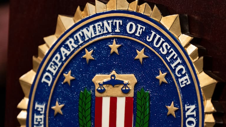 An FBI seal is displayed on a podium.