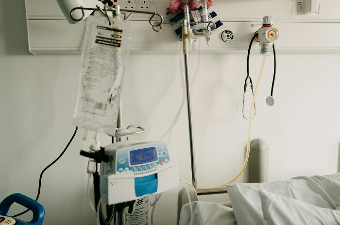IV drip and medical equipment next to a hospital bed, illustrating patients leaving the hospital against medical advice.