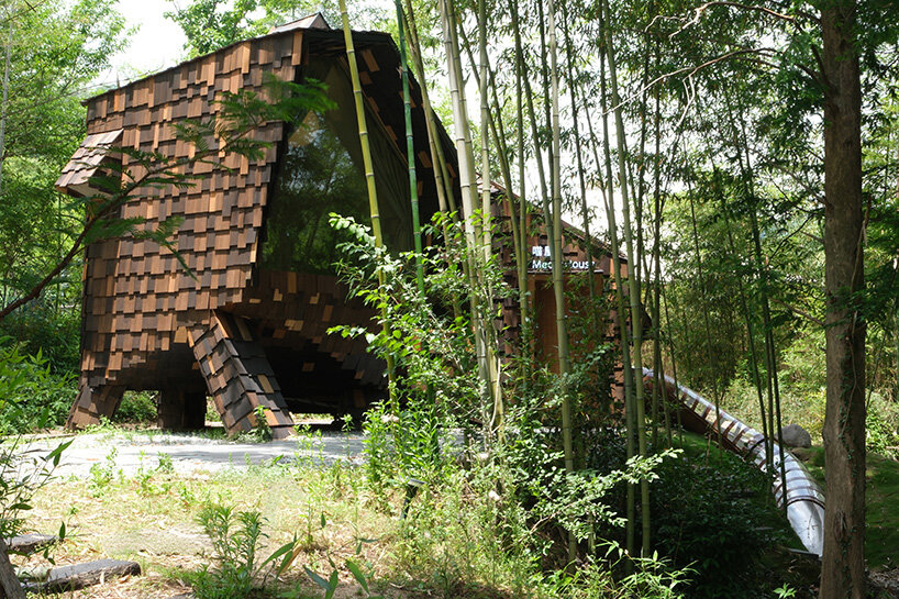 patchwork exterior of 'cat house' in china's anji forest is clad in discarded bamboo tiles