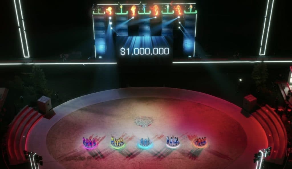 Players watching the Captain's Bribe reaching $1 million in Beast Games Season 2