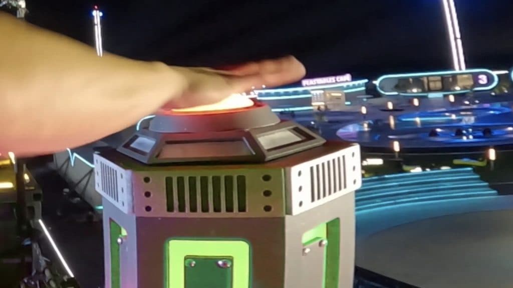 A contestant's arm pushes a button in Beast Games Season 2