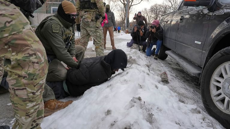 Border Patrol agents detain a man in Minneapolis. 
