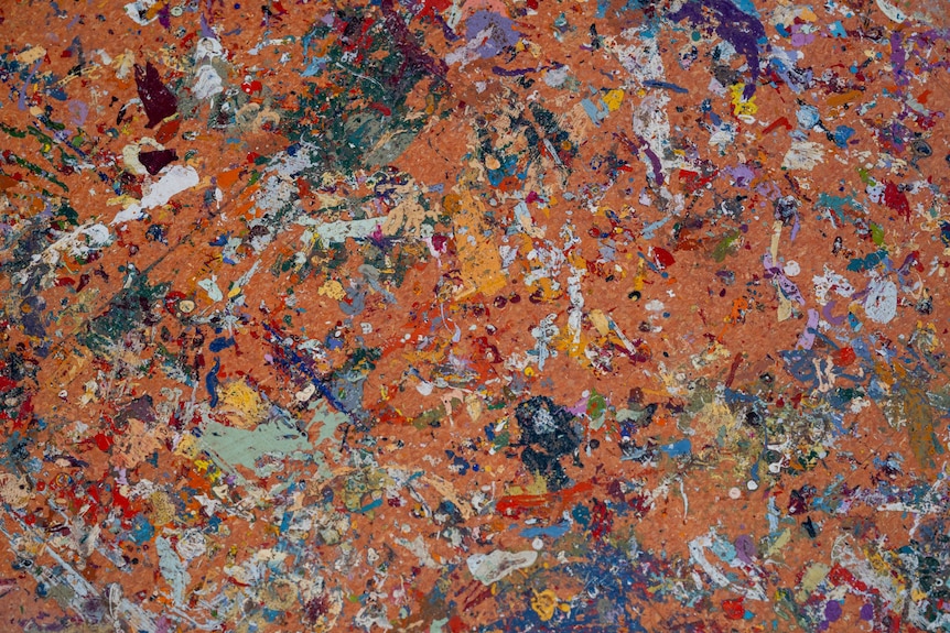 Various colours of paint on the floor. 