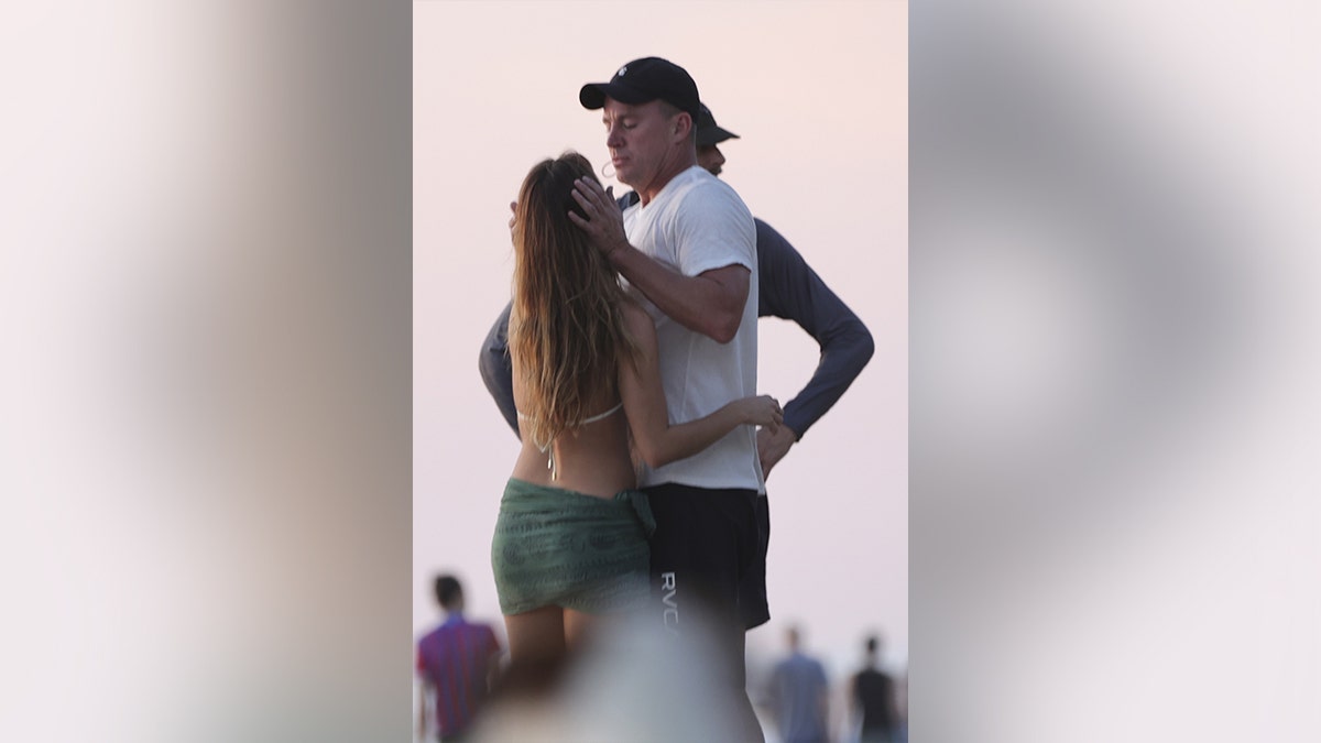Channing Tatum and his girlfriend embracing on the sand in Costa Rica.