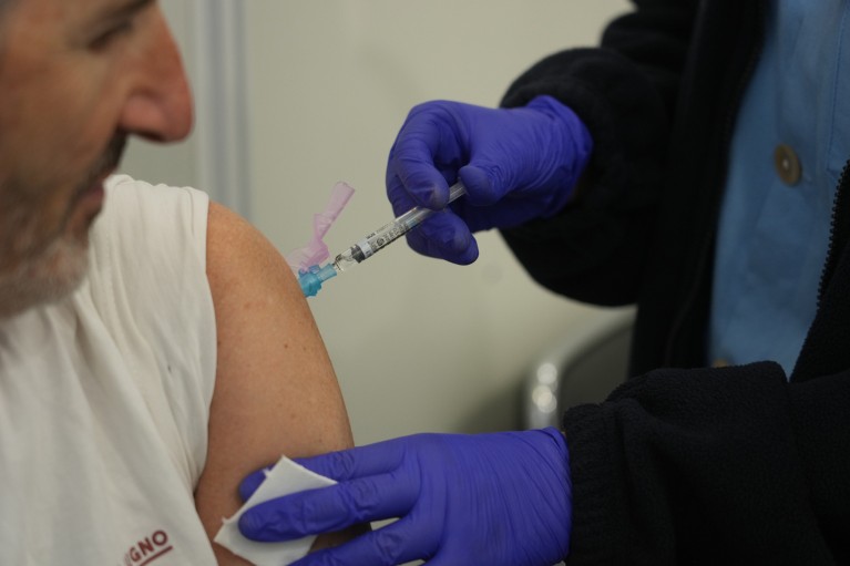 Close up of a man receiving a vaccine in his arm