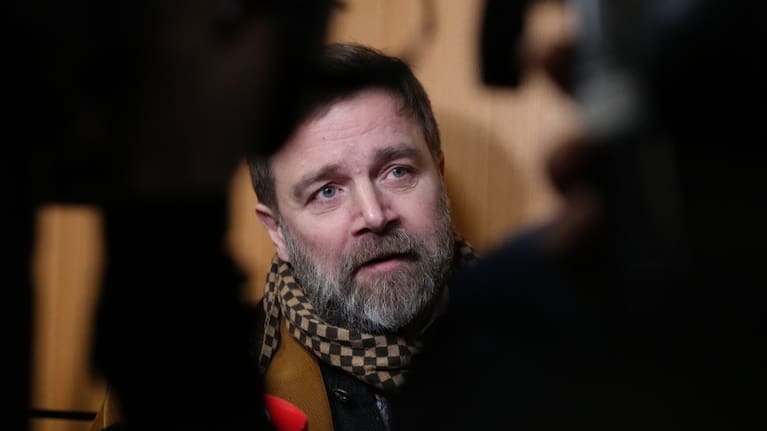 Defendant Bertrand Scholler answers reporters after a Paris court has found 10 people guilty of cyberbullying France's first lady, Brigitte Macron.