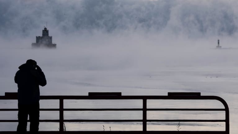 Doug Kunde watches as steam is seen over Lake Michigan.