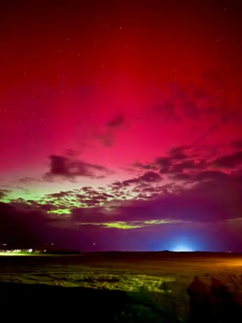 JODIE SEABROOK Red and greeny yellow northern lights  over Alderney 