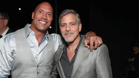 Getty Images Dwayne Johnson and George Clooney