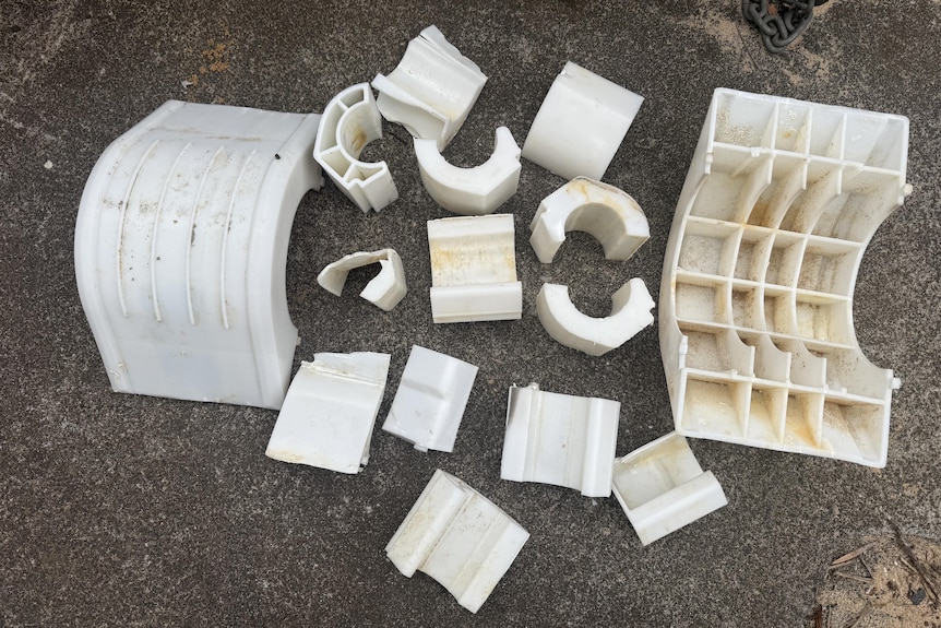 White plastic objects laid out on the ground.