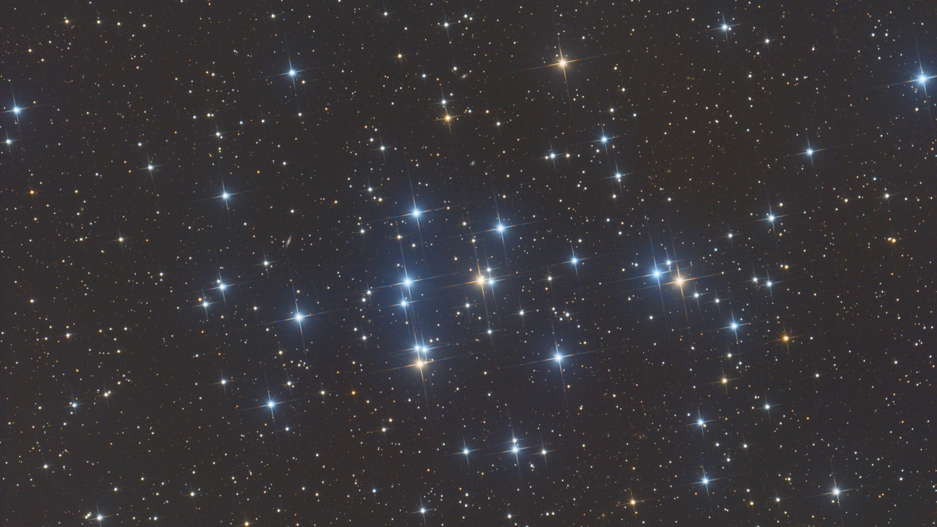 Several bright stars of the Beehive Cluster, a group of roughly 1,000 tight-knit stars