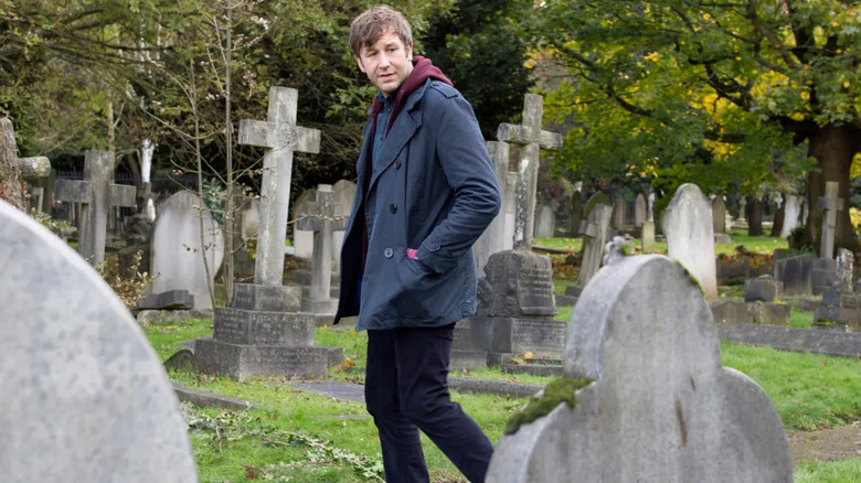 Tom Chadwick (Chris O'Dowd) walks through a cemetery in Family Tree