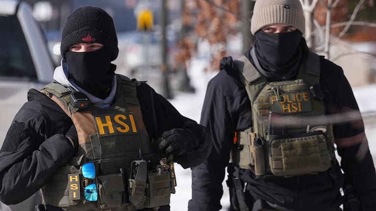 Federal agents stand outside of a property in St Paul, Minnesota.