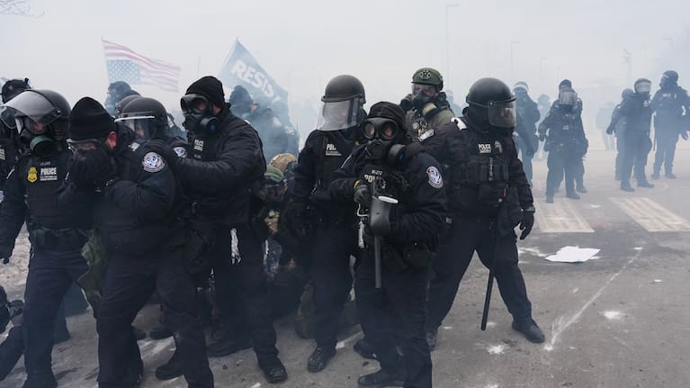 Federal immigration officers confront protesters outside Bishop Henry Whipple Federal Building, Thursday, January 15, 2026, in Minneapolis.