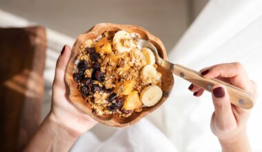 Photo of a bowl full of granola, fruit and porridge.