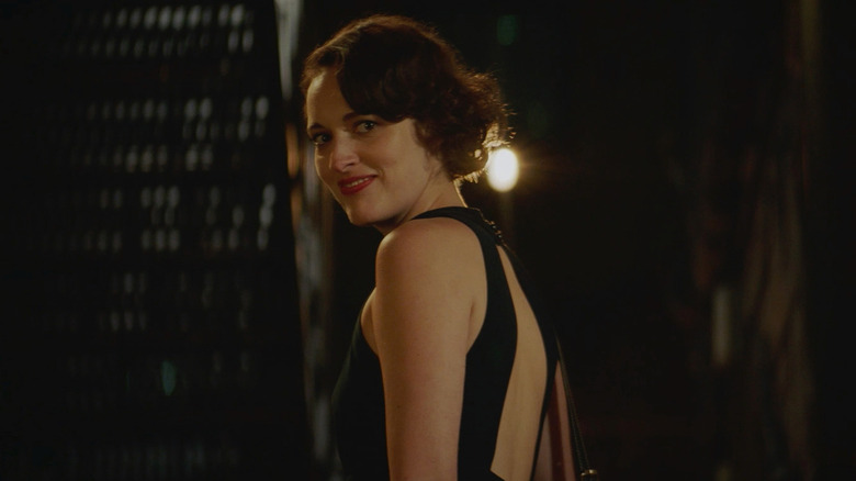 Phoebe Waller-Bridge as Fleabag looking behind her and smiling in Fleabag