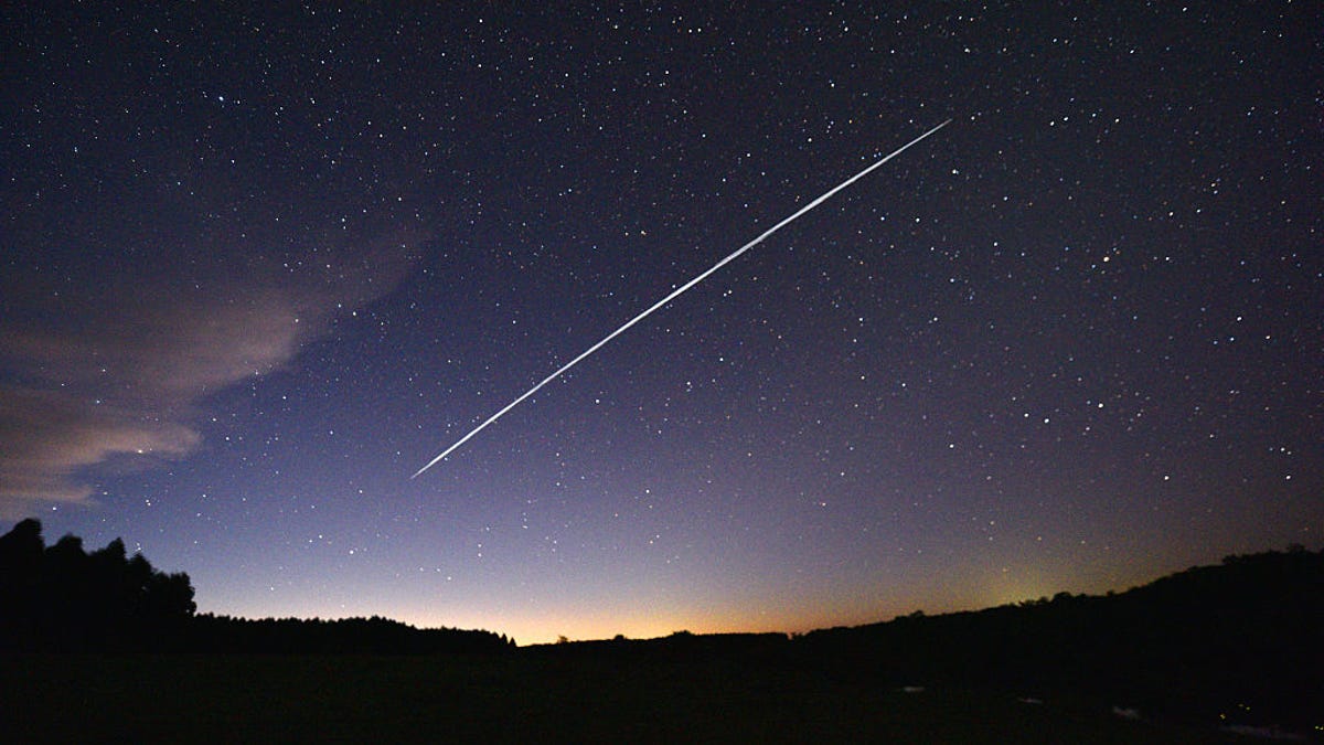 gorgeous purple night sky with long white streak