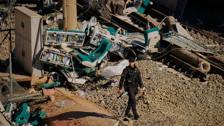 Guardia Civil officers collect evidence next to the wreckage of train cars involved in a collision in Adamuz, southern Spain