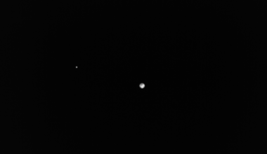 Spacecraft watches lonely Earth and moon fade into the distance