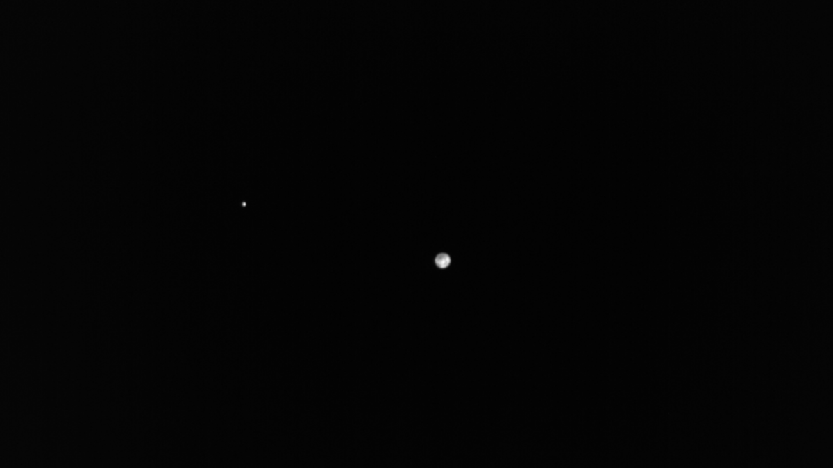 Spacecraft watches lonely Earth and moon fade into the distance