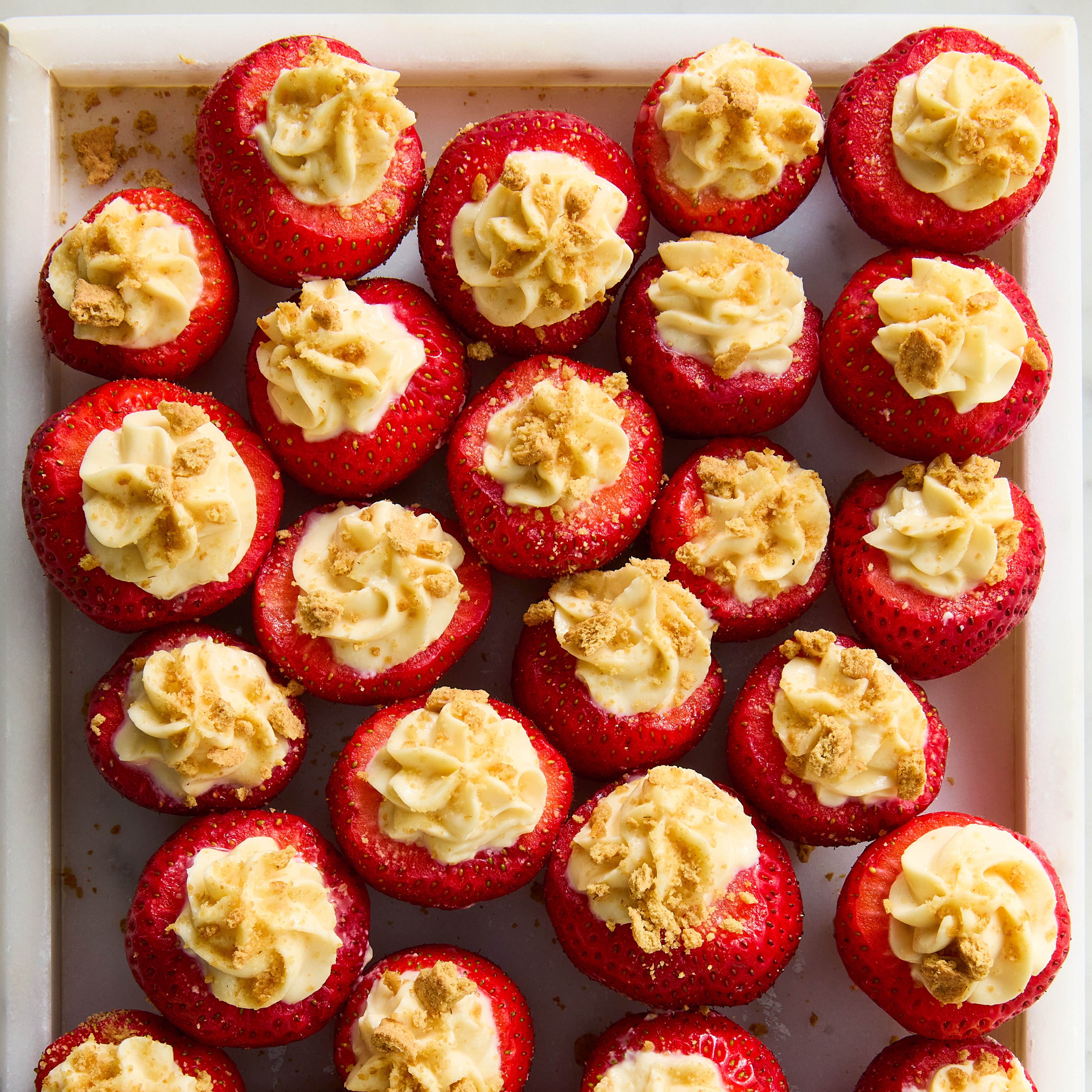 strawberries stuffed with a high protein cheesecake mixture topped with graham cracker crumbs