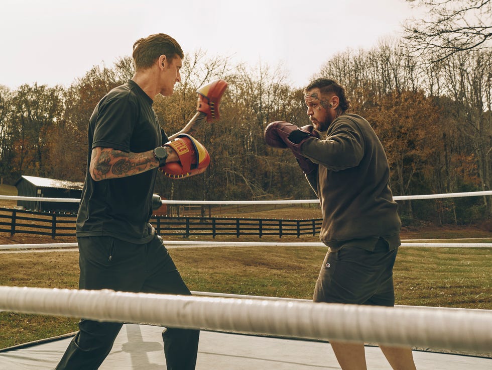 boxers sparring in a training ring outdoors