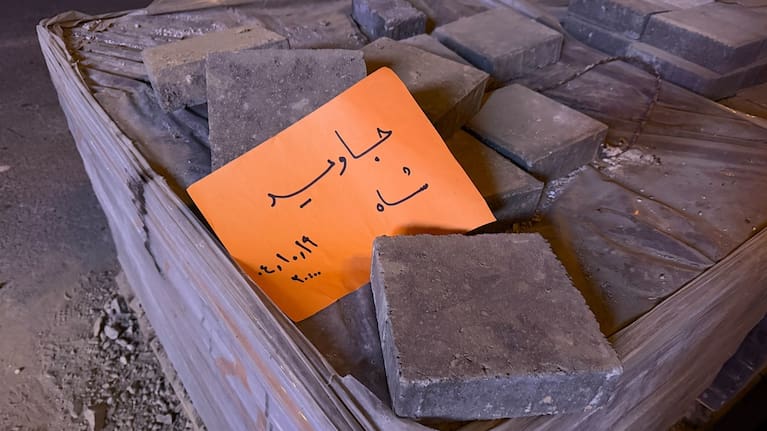 A placard is placed on bricks that reads in Farsi, "Long live the Shah," referring to the Pahlavi dynasty that was toppled in the 1979 Islamic Revolution.