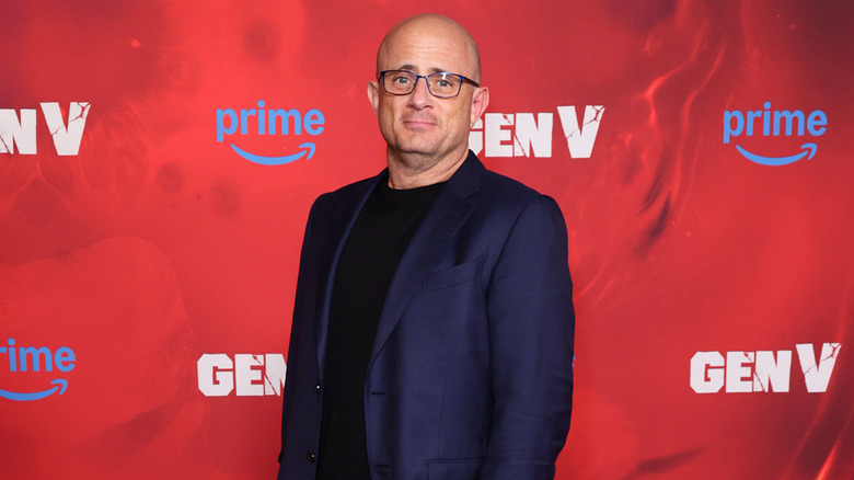 Eric Kripke smiling and wearing glasses