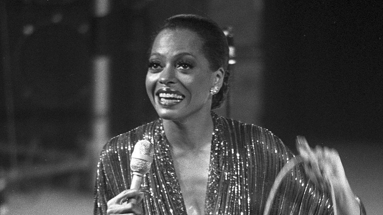Diana Ross singing on stage in sparkly dress