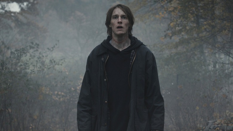 Jonas Kahnwald (Louis Hofmann) stands in a foggy forest in Dark