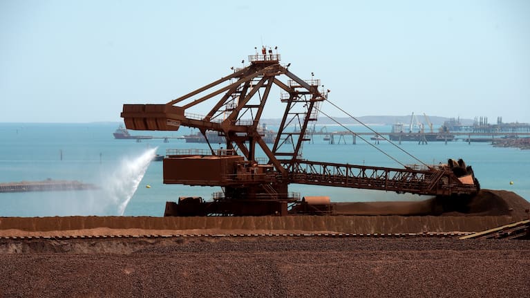 Iron ore stockpiles waiting to be transported from Karratha, Western Australia, 2023. Iron ore is Australia's most lucrative product, followed by coal, then gold.