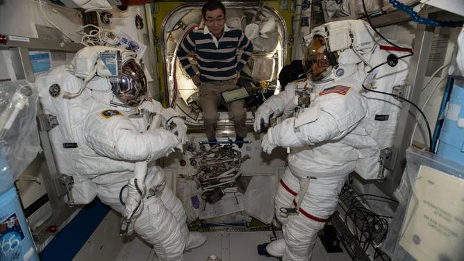 Dec. 30, 2025: At center, JAXA (Japan Aerospace Exploration Agency) astronaut and Expedition 74 Flight Engineer Kimiya Yui assists NASA astronauts Zena Cardman (left) and Mike Fincke (right), the station’s flight engineer and commander respectively, during spacesuit checks inside the International Space Station’s Quest airlock.