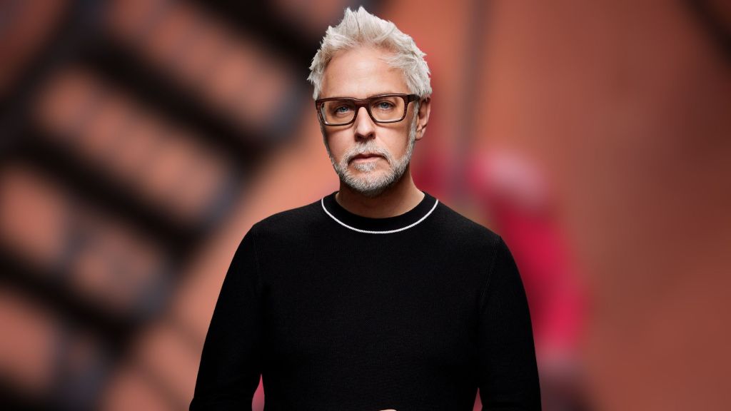 James Gunn in front of an image from Super.