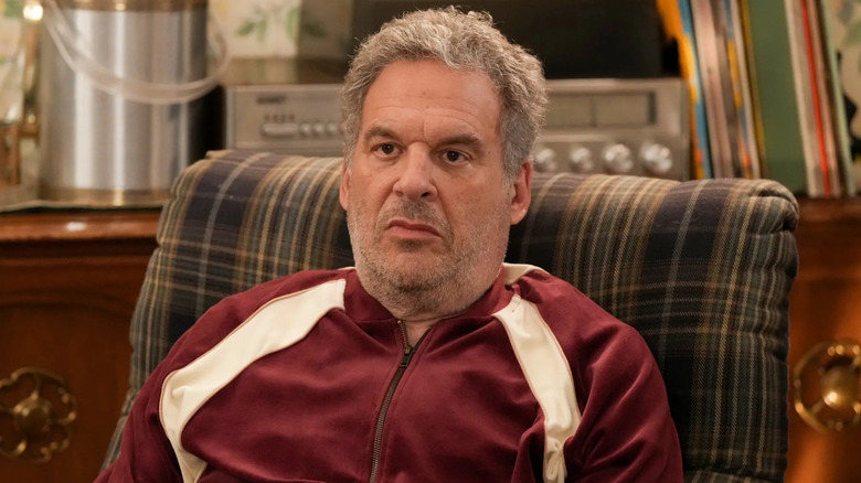 Jeff Garlin as Murray sitting in a chair in The Goldbergs